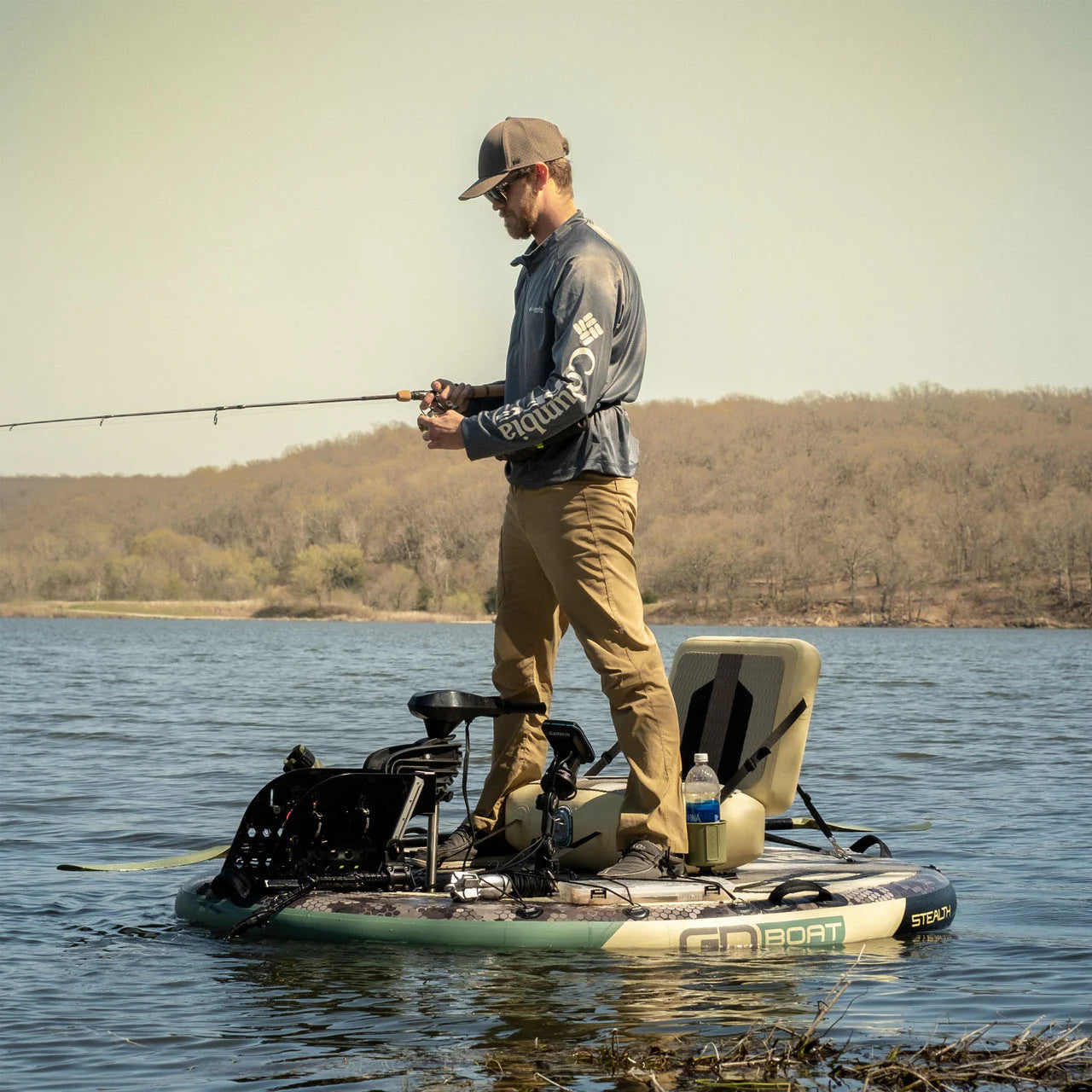 Angler standing and fishing from a GoBoat Fish inflatable electric boat on a lake